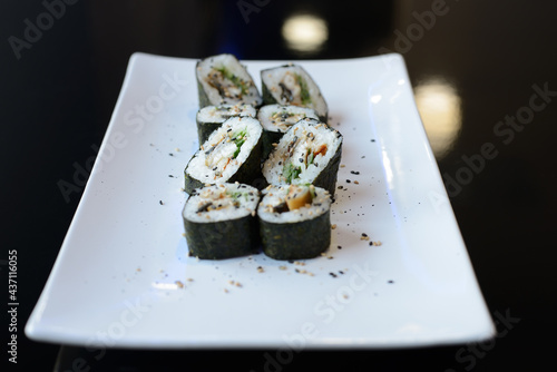 Sushi rolls on white dish. Japanese food.