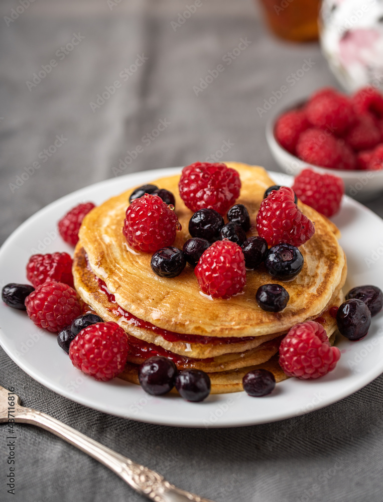 Sweet homemade pancakes with fruits on white plate. Sweet homemade pancakes with fruits on white plate.