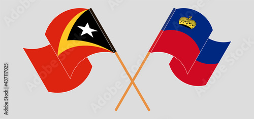 Crossed and waving flags of East Timor and Liechtenstein