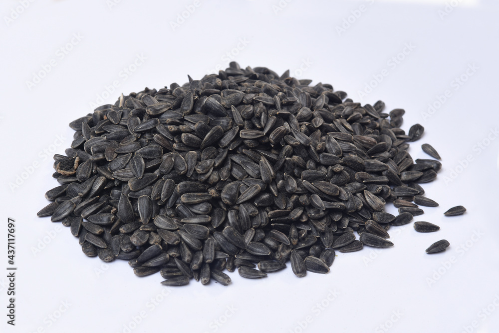 heap of black sunflower seeds isolated on white heap of black sunflower seeds isolated on white