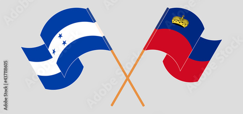 Crossed and waving flags of Honduras and Liechtenstein