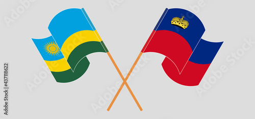 Crossed and waving flags of Rwanda and Liechtenstein