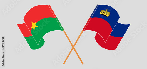 Crossed and waving flags of Burkina Faso and Liechtenstein