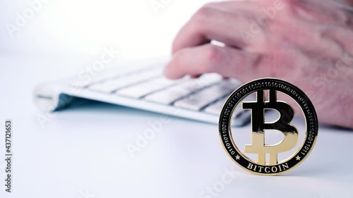 Trade bitcoin. Golden Bit Coin virtual cryptocurrency or blockchain technology. Gold Crypto currency BTC Bitcoin with keyboard on white background. Block chain, network connect concept