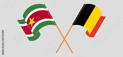 Crossed and waving flags of Suriname and Belgium photo