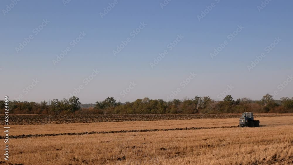 the tractor plows the field in autumn the tractor plows the field in autumn