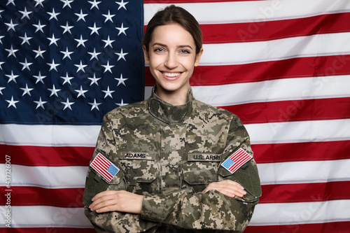 Portrait of happy female cadet against American flag photo