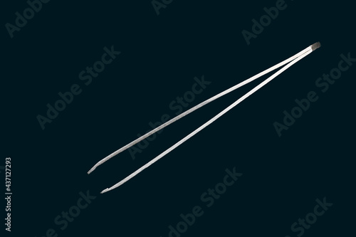 Close up of a tweezer isolated on a black background