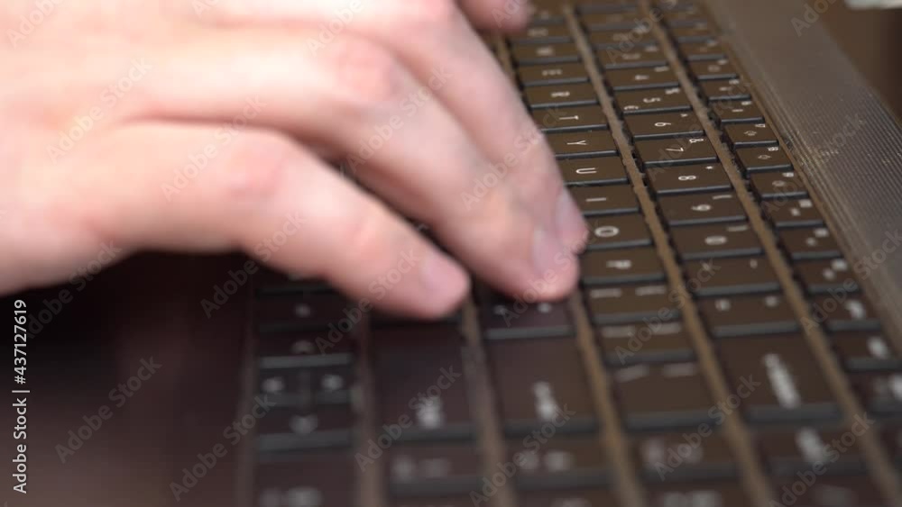 Male hands typing on a laptop keyboard, self-isolation work, online correspondence Male hands typing on a laptop keyboard, self-isolation work, online correspondence