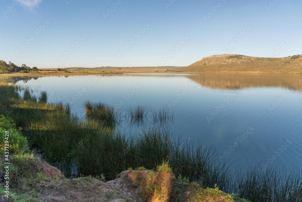 Small lagoon at the foot of the mountain ranges in the countryside of Argentina