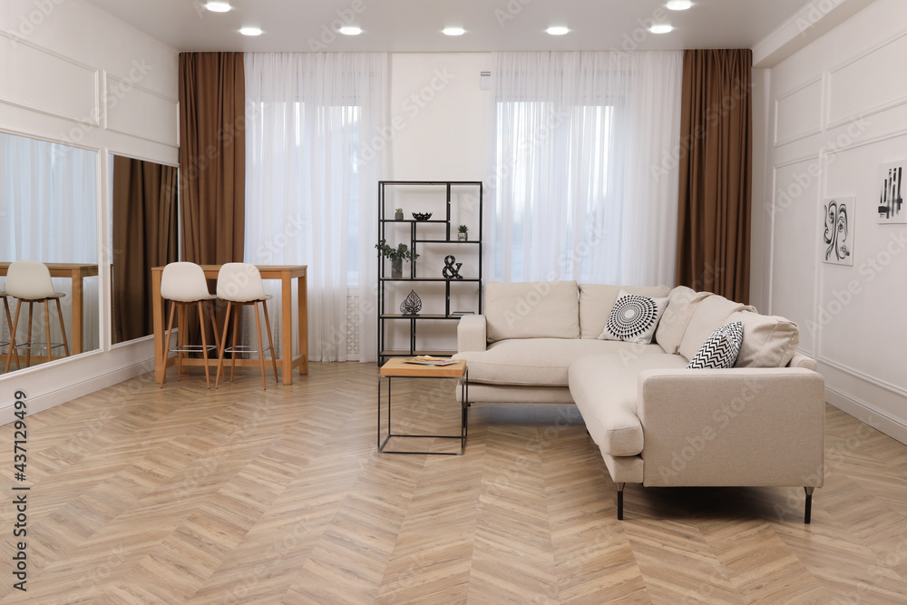 Modern living room with parquet flooring and stylish furniture Modern living room with parquet flooring and stylish furniture