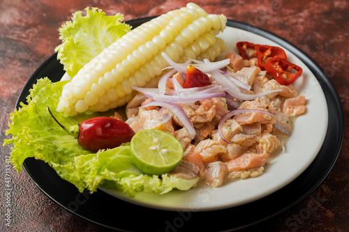 ceviche de trucha con choclo, cebolla y ají limo, comida peruana photo