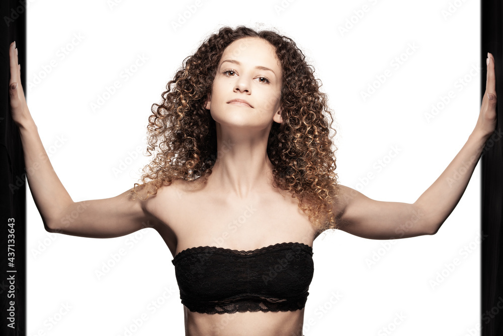 Beautiful brunette girl with long curly hair standing. Studio portrait with black stripes Beautiful brunette girl with long curly hair standing. Studio portrait with black stripes