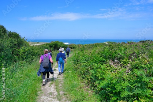 group of senior hikers on the path at "Ile Grande" in Brittany. France