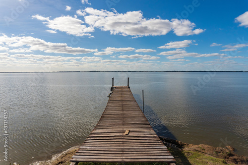quiet lagoon with small wooden pier and birds resting in Argentina