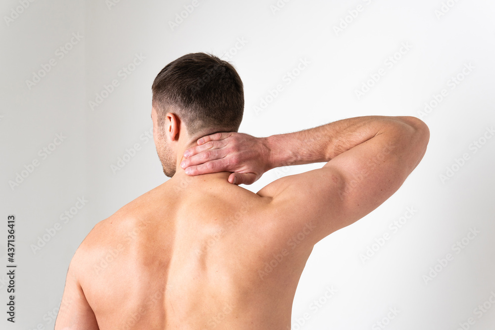 The muscles of the neck in a man on a white background are hurt ache sore injury, ill person isolated background expression. Tension lumbar care, back suffer attractive