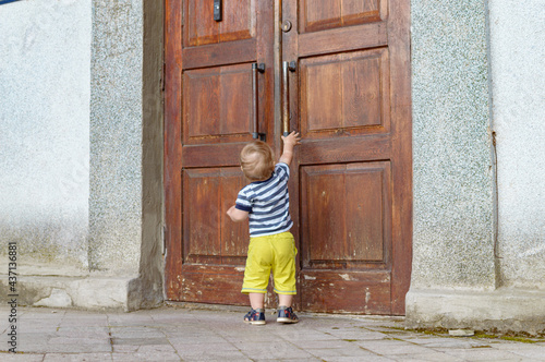 child pulling on the door