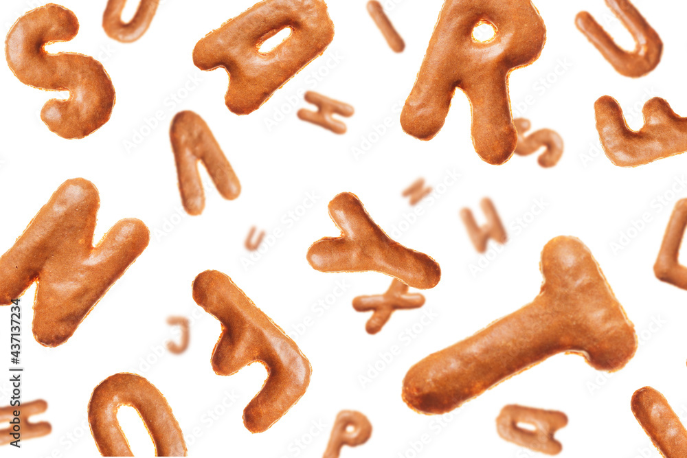 Chaotic flying letters made of real cookies, isolated on white background, closeup Chaotic flying letters made of real cookies, isolated on white background, closeup