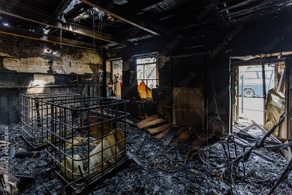 Burnt out shop after fire with charred walls and remains of furniture Burnt out shop after fire with charred walls and remains of furniture