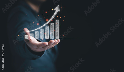 Businessman holding drawing white graph and chart with copy space , Trading in stock market and technical analysis concept.