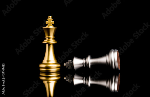 Golden king chess standing and silver king chess falling for the winner , Business competitor and strategy concept.