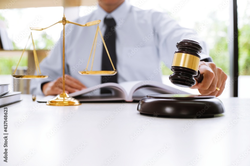 Lawyer Legal counsel presents to the client a signed contract with gavel and legal law. justice and lawyer Business partnership meeting concept. Lawyer Legal counsel presents to the client a signed contract with gavel and legal law. justice and lawyer Business partnership meeting concept.