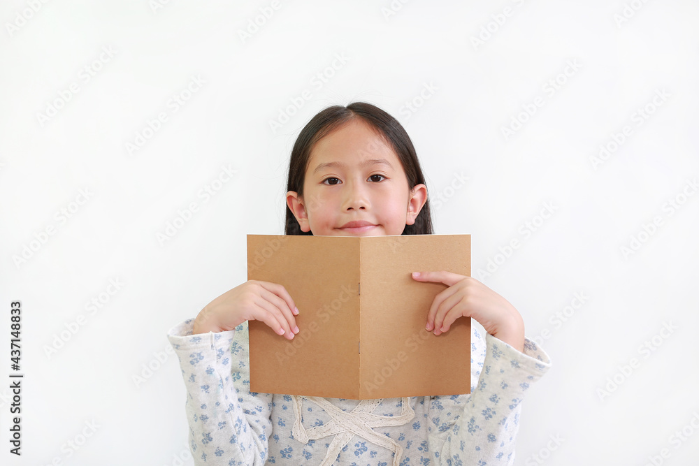 Asian little girl child holding open brown book with looking at camera isolated over white background Asian little girl child holding open brown book with looking at camera isolated over white background