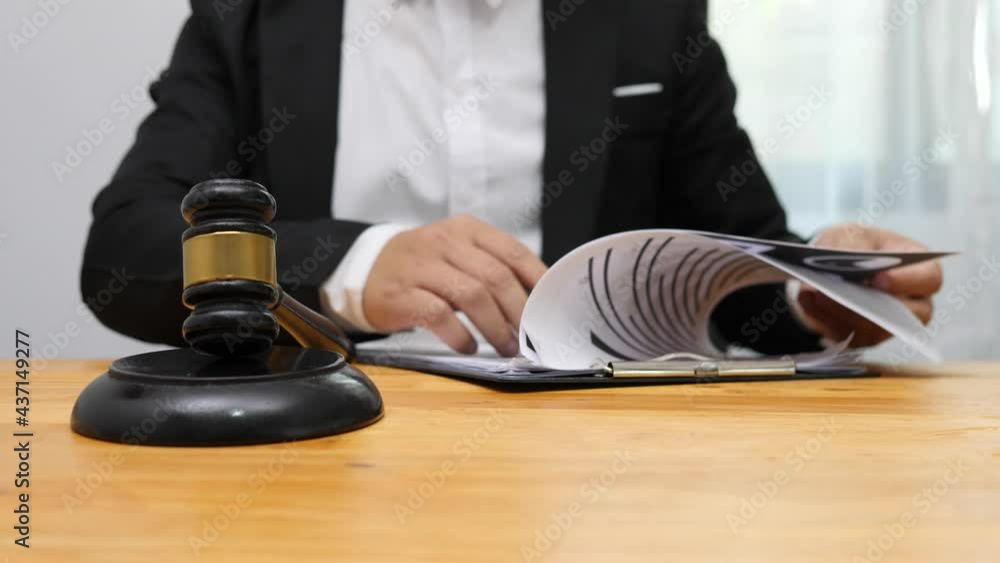 Consult Judge or lawyer Hand Writing Document in Court Room. Consult Judge or lawyer Hand Writing Document in Court Room.
