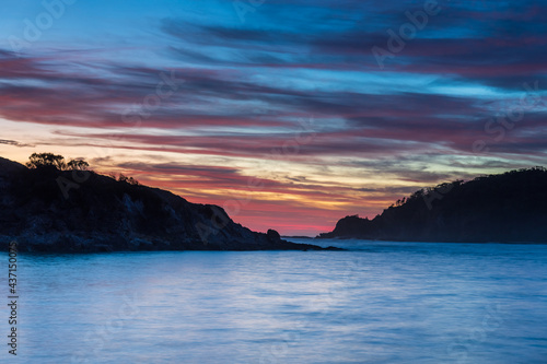 Colourful High Cloud Sunrise Seascape and Rock Formations