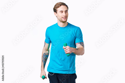handsome sporty man holding dumbbells fitness exercise light background © SHOTPRIME STUDIO