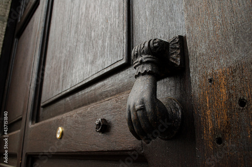 old door knocker with the shape of a hand