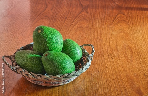 Avocados on a wooden table. Raw and fresh avocados