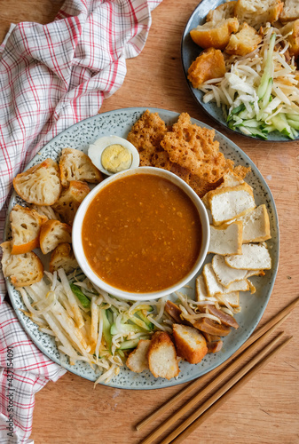 Popular Indian gourmet in Malaysia / Rojak or Pasembur / Fried dough shrimp fritters, tofu, egg, spicy cuttlefish, shredded cucumber, turnip and bean sprouts in thick and spicy peanut gravy sauce