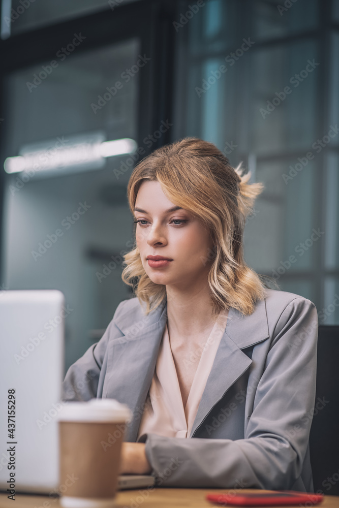 Beautiful young woman at table with coffee and laptop Beautiful young woman at table with coffee and laptop