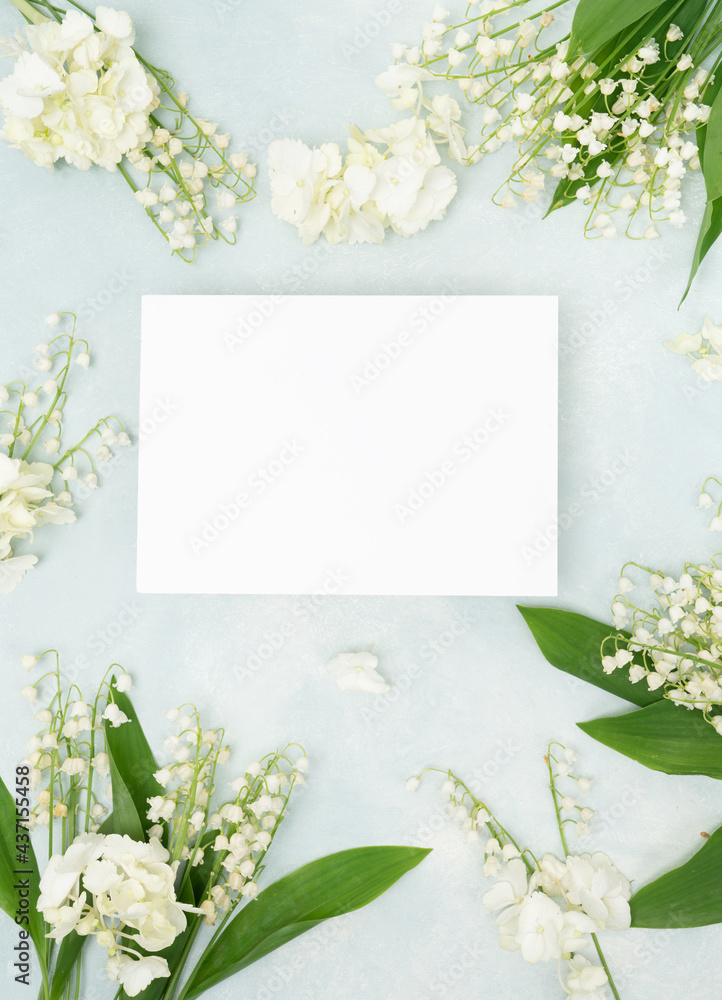 Lilly of the valley bridal floral flat lay with blank stationery card