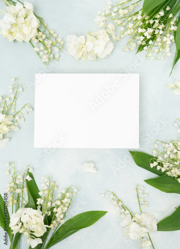 Lilly of the valley bridal floral flat lay with blank stationery card
