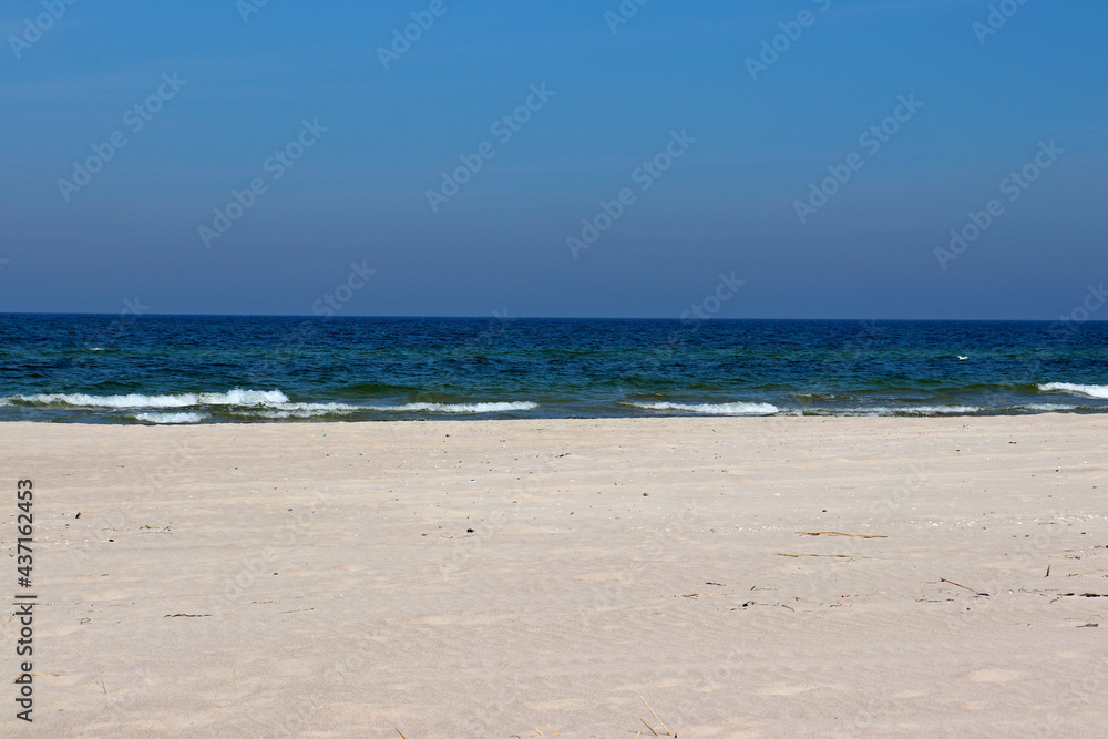 Warm sea sand on the Baltic Sea beach, Dziwnów, Poland Warm sea sand on the Baltic Sea beach, Dziwnów, Poland