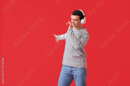 Handsome young man listenin...