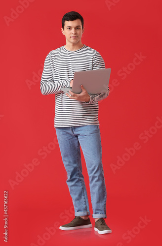 Handsome young man using la...