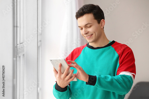 Handsome young man using ta...