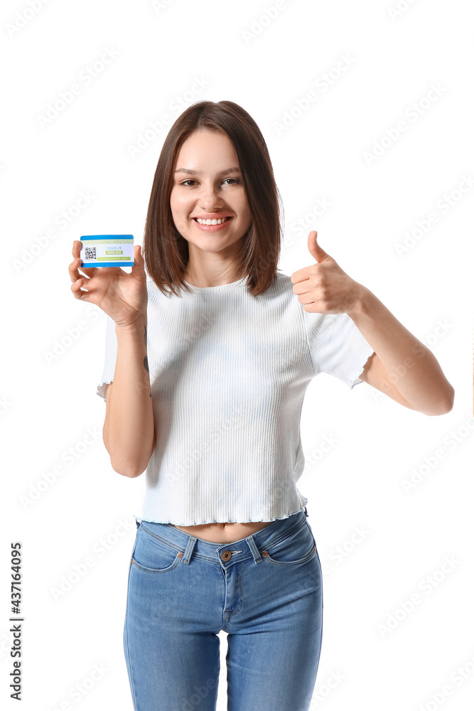 Young woman with covid-19 vaccination card showing thumb-up on white background Young woman with covid-19 vaccination card showing thumb-up on white background