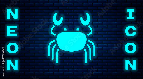 Glowing neon Crab icon isolated on brick wall background. Vector
