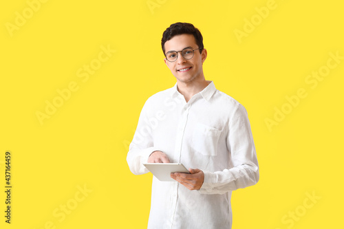 Handsome young man with tab...