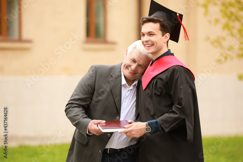 Happy young man with his father on graduation day photo
