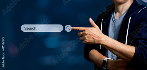 Man touching on search icon on virtual screen. Panoramic of Searching internet data Information Concept with copy space