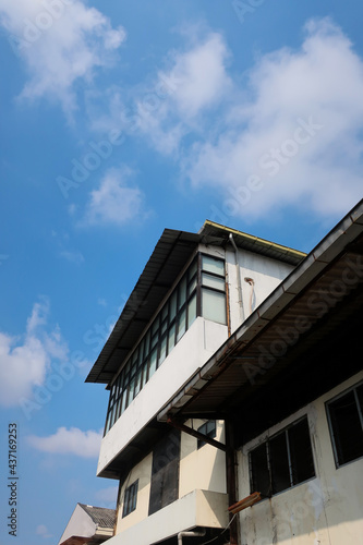 Part of the old building in the photo from below. condition of the building with a blue sky background during the day, Surabaya, East Java, Indonesia 06-2021.