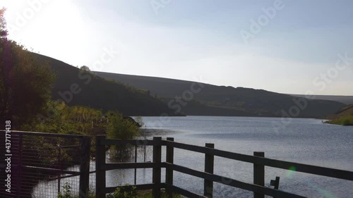 Hills and lakes of water through view of wooden posts  photo