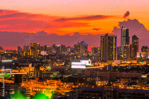 The high angle background of the city view with the secret light of the evening, blurring of night lights, showing the distribution of condominiums, dense homes in the capital community