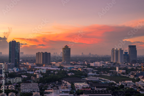 Wallpaper High angle of the city view with the secret light of the evening sun the blurred lights of the night,showing the distribution of condominiums, densely residential houses in the capital © bangprik