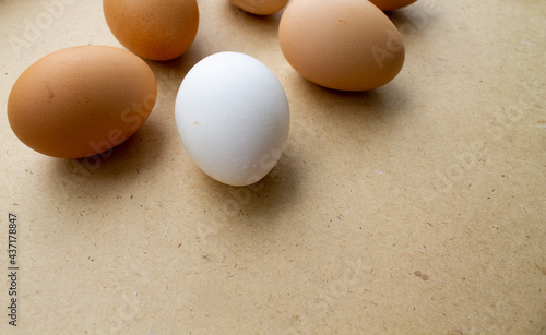 the eggs lie loosely on the brown table.
